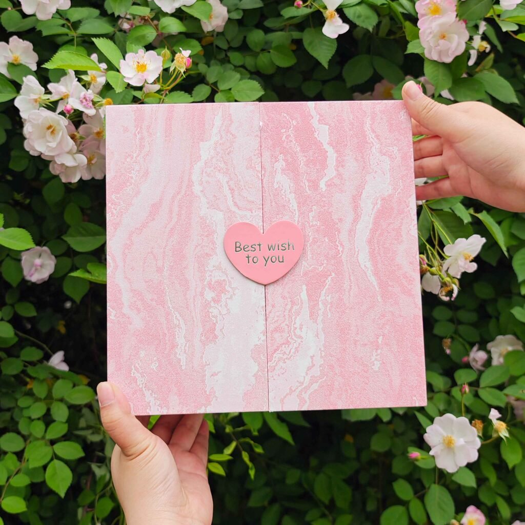 Double door gift box opened showing heart shaped silver hot stamping closure – romantic unboxing experience