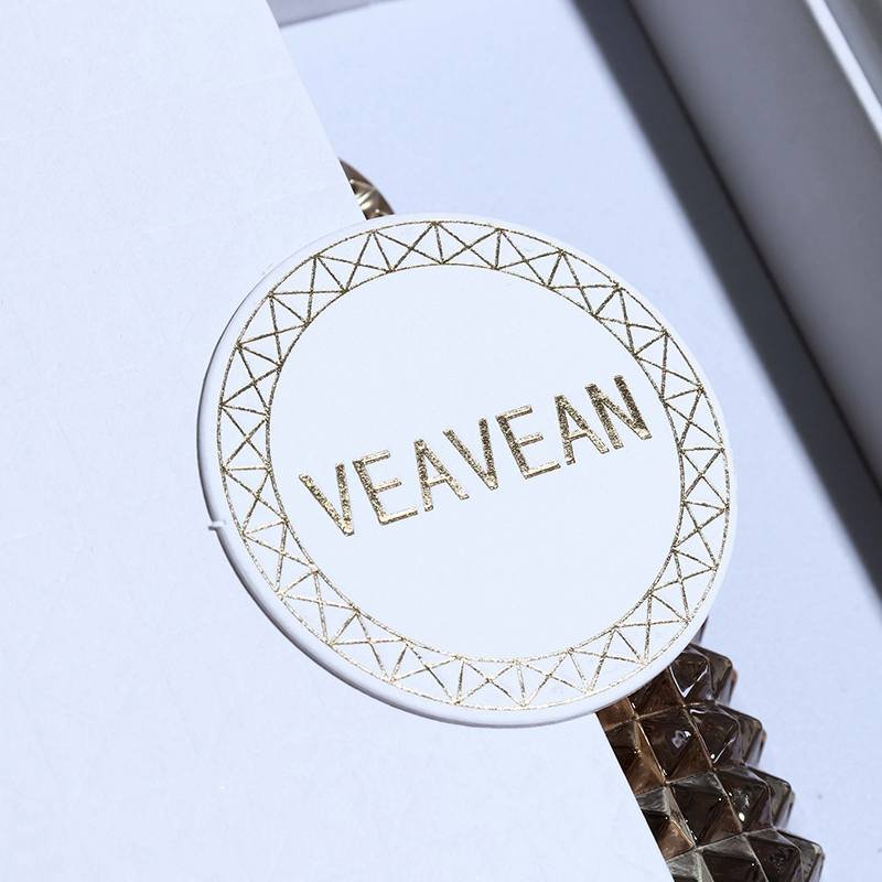 White Luxury Perfume Box – Double Door Custom Logo Packaging Gold hot stamping logo closeup – circular brand mark, showcasing brand charm