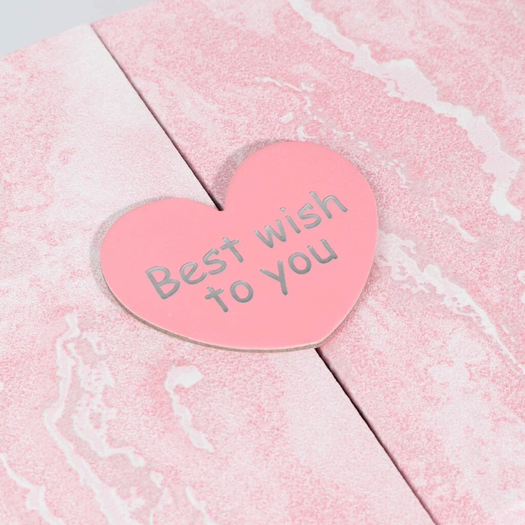 Heart shaped closure with silver hot stamping on pink gift box – elegant love themed packaging