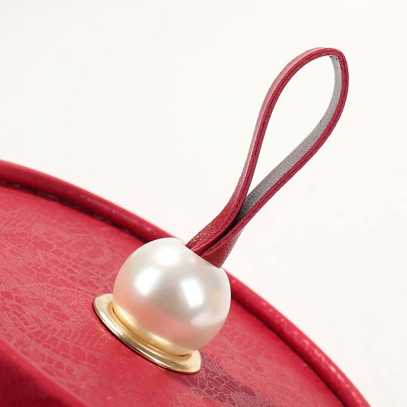 Pearl and leather handle closeup – graceful lid opening for ceremonial unboxing