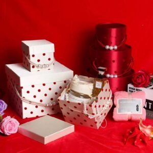 Red round satin polka-dot gift box closed – luxurious fabric with braided cord bead handle